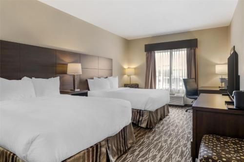 a hotel room with two beds and a television at Best Western Plus Bridgewater Hotel & Convention Centre in Bridgewater