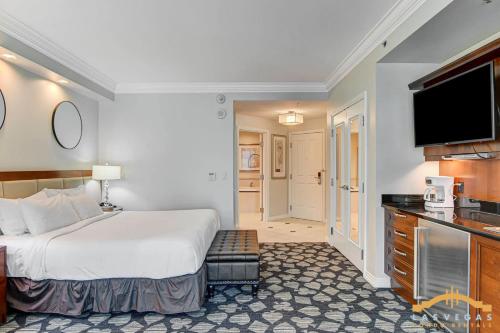a hotel room with a bed and a flat screen tv at MGM Signature-22-711 Strip View Jacuzzi Studio in Las Vegas