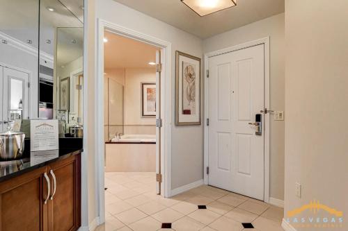 a kitchen with a door leading to a bathroom at MGM Signature-22-711 Strip View Jacuzzi Studio in Las Vegas