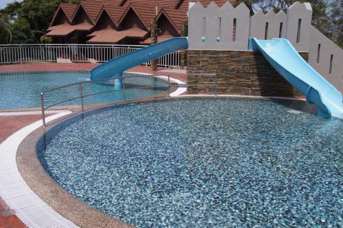 a slide in the middle of a swimming pool at The Jerai Hill Resort in Yan