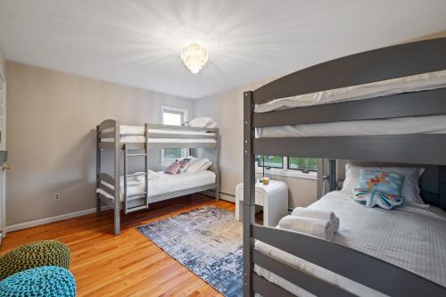 a bedroom with two bunk beds and a mirror at Huge Retreat w Alaska King, Pool & Jacuzzi Tub Indoor in Goshen