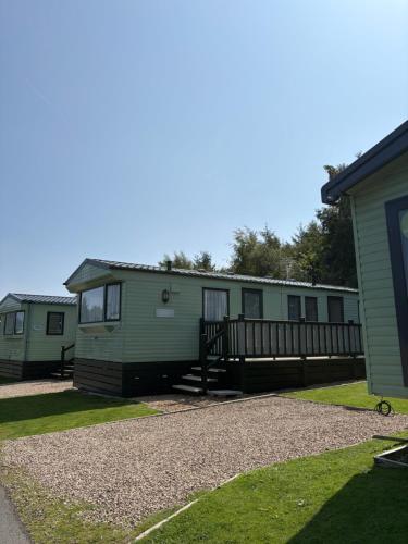 a row of mobile homes in a yard at Slaley Forest Hexham Caravan Retreat Pet Friendly - sleeps 6 in Slaley