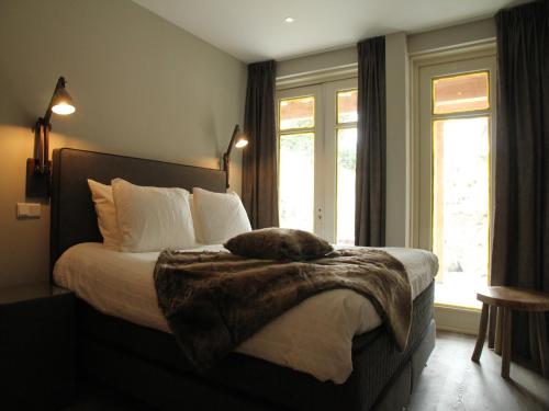 a bedroom with a bed with a fur blanket on it at Holiday Home with bubble bath in Noordwijk in Noordwijk