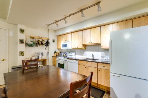 a kitchen with a wooden table and a refrigerator at half Mi to Metrobus Stop! Walkable Petworth Duplex in Washington