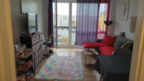 a living room with a red couch and a rug at Harmonie in Coswig