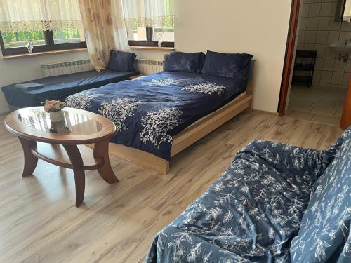 a living room with a couch and a table at HOTEL&Restaurant DALLAS in Myślenice