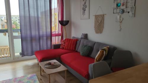 a living room with a red couch and a window at Harmonie in Coswig