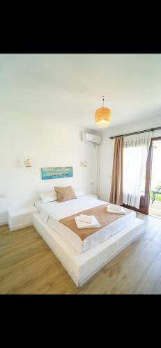 a large white bedroom with two beds in it at Dut Selimiye in Marmaris