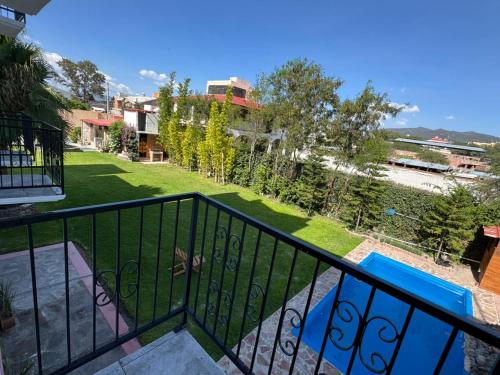 a balcony with a view of a yard at Posada Terra Santa in Tequisquiapan