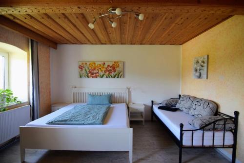 a bedroom with a bed and a couch at Stilvolle, vollausgestattete 120m2 Wohnung mit Bauernhoferlebnis in Sankt Martin am Ybbsfelde