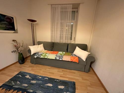 a living room with a couch and a window at Goetheanum Casa in Dornach