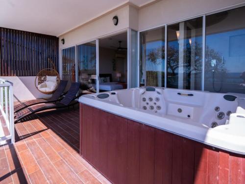 a large bathroom with a tub on a balcony at Casa White#2 Beautiful modern beach house in Sámara