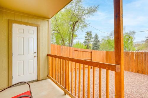 a porch with a white door and a fence at Walk to Downtown Prescott with Fenced Yard! in Prescott