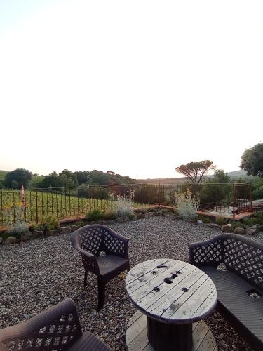 a wooden table and chairs and a table and a table and chairs at Casa vacanze "LA FORNACE" in Vagliagli