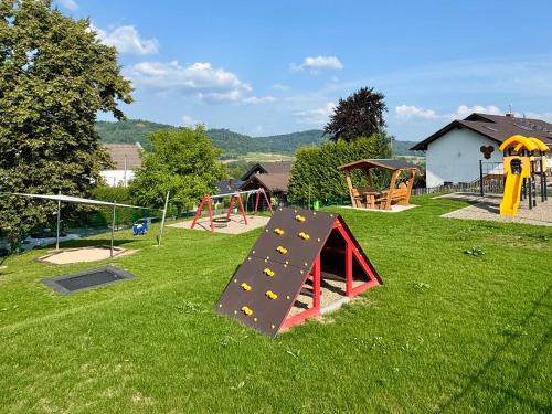 a playground with a slide and a play structure at Bergjuwel mit Ruhe & Komfort - M20 - Frankenwald Apartments in Stadtsteinach