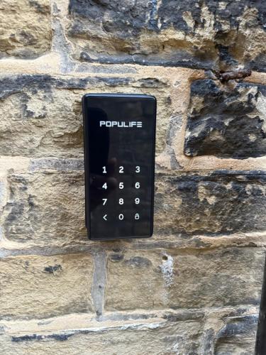 a remote control on the side of a stone wall at St Matthews View in Halifax