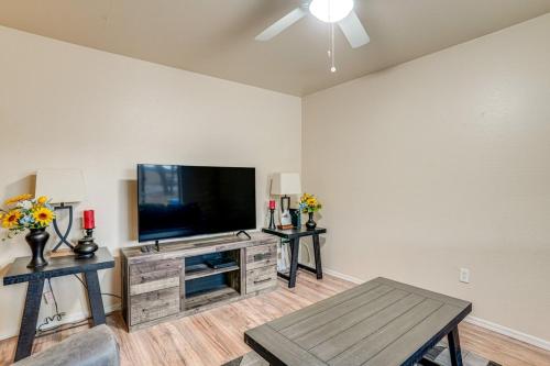 a living room with a flat screen tv on a wall at Walk to Downtown Prescott with Fenced Yard! in Prescott