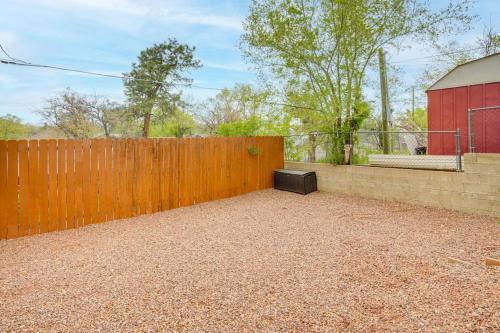 a backyard with a wooden fence next to a building at Walk to Downtown Prescott with Fenced Yard! in Prescott