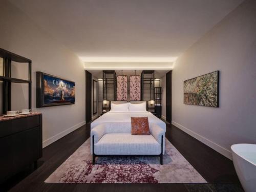 a bedroom with a bed and a chair and a sink at Chongqing KS Kongshang Hotel in Chongqing