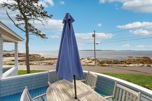 a blue umbrella sitting on top of a table at Tranquil Ocean Retreat in Boothbay
