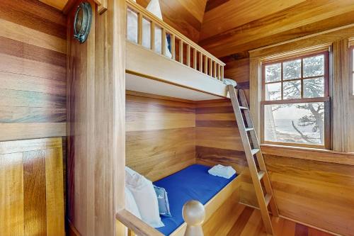 a tiny house with a bunk bed and a ladder at Tranquil Ocean Retreat in Boothbay