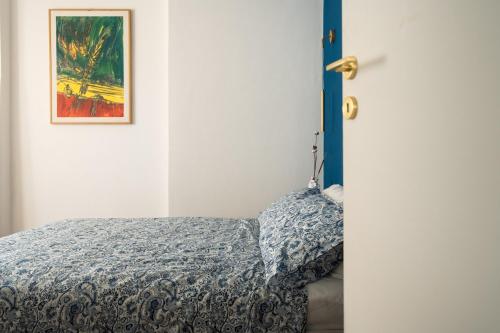 a bedroom with a bed and a picture on the wall at LUXURY - Casa dell'artista in Grottammare