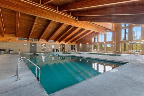 a large indoor swimming pool in a building at AmericInn by Wyndham Green Bay East in Green Bay