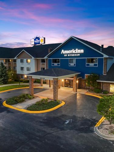 a hotel with a parking lot in front of it at AmericInn by Wyndham Green Bay East in Green Bay