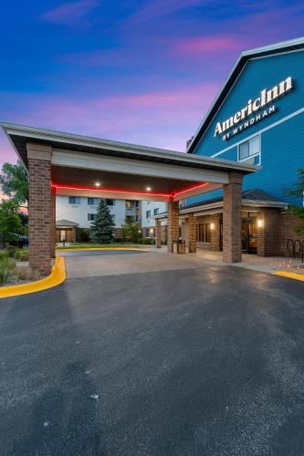 an empty parking lot in front of an apartment building at AmericInn by Wyndham Green Bay East in Green Bay