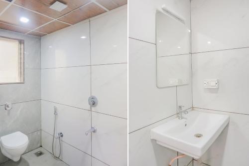 a white bathroom with a sink and a toilet at Hotel O Rest Inn in Yeraoda