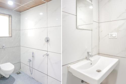 a white bathroom with a sink and a toilet at Hotel O Rest Inn in Yeraoda