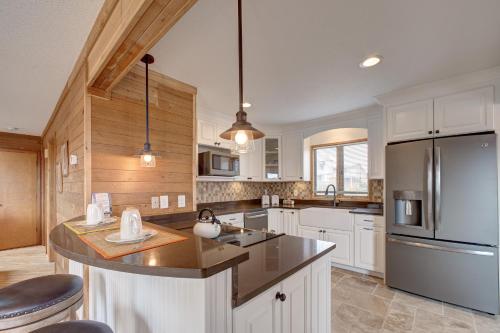 a kitchen with white cabinets and a stainless steel refrigerator at Idle Minds 84 in Salvo