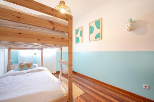 a bedroom with two bunk beds in a room at Cozy Traveller Apartment & Garage in Aveiro
