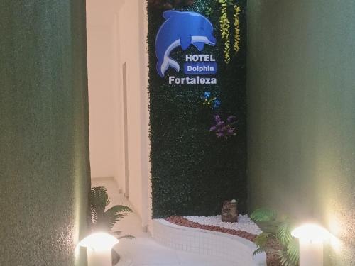a banner with a blue dolphin on a wall with lights at Hotel Dolphin Fortaleza in Fortaleza