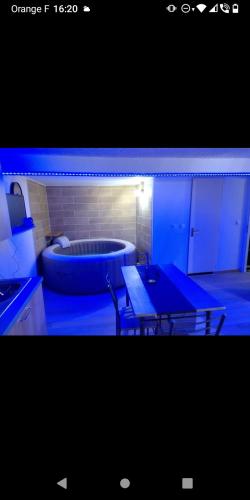 a room with a tub and a table in front of it at Bas de villa à 100 M de la plage in Solaro