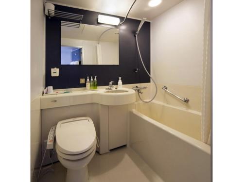 a bathroom with a toilet and a sink and a tub at Smile Hotel Tokushima - Vacation STAY 61133v in Tokushima