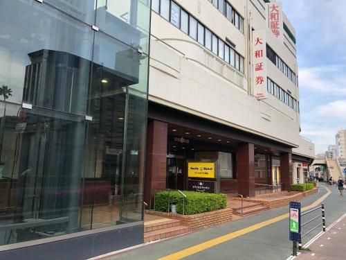 a glass facade of a building on a street at Smile Hotel Tokushima - Vacation STAY 61133v in Tokushima