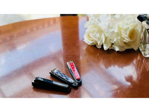 two remote controls and a bouquet of flowers on a table at Shinyokohama Kokusai Hotel - Vacation STAY 62845v in Yokohama
