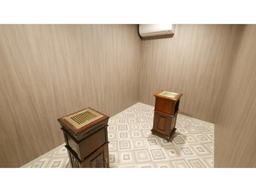 a room with two wooden tables and a heater at Shinyokohama Kokusai Hotel - Vacation STAY 62845v in Yokohama