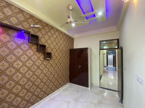 a living room with a ceiling fan and a door at Kashi Gange in Varanasi