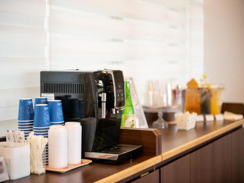 a coffee maker sitting on a counter with paper cups at Smile Hotel Kushiro - Vacation STAY 69842v in Kushiro