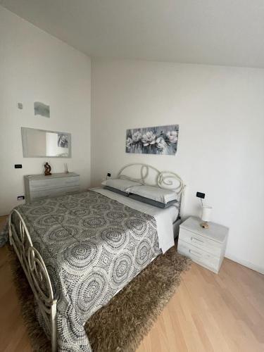 a bedroom with a bed and two night stands at B&B Le Peonie Alloggio centrale vicino al mare in Ravenna