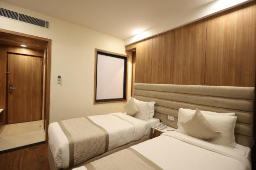 Postel nebo postele na pokoji v ubytování Rukman Hotels