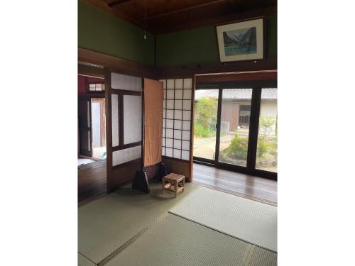 a room with green walls and windows and a stool at Grannys House - Vacation STAY 19625 in Awaji