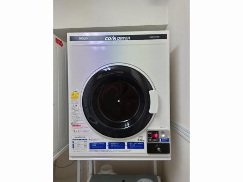 a washing machine in the corner of a room at Smile Hotel Nagoya Shinkansenguchi - Vacation STAY 77730v in Nagoya