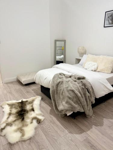 a bedroom with a bed and a rug on the floor at Edgbaston Retreat-Birmingham City Centre-Double Room in a shared two bedroom apartment in Birmingham