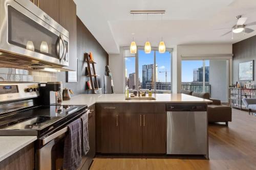 a kitchen with a sink and a stove top oven at The Stevie Ray Vaughan Flat ATX in Austin