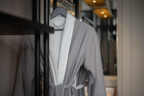 a white shirt is hanging on a rack at Chongqing KS Kongshang Hotel in Chongqing