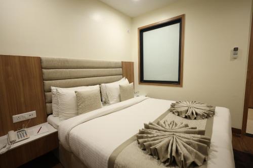 Postel nebo postele na pokoji v ubytování Rukman Hotels
