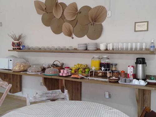 a counter with food on it in a kitchen at Chalés Caraguá Massaguaçu in Caraguatatuba